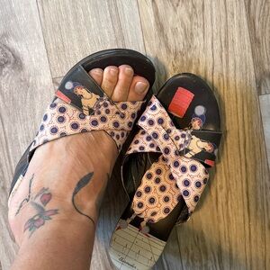 Icon tattooed, leather sandal